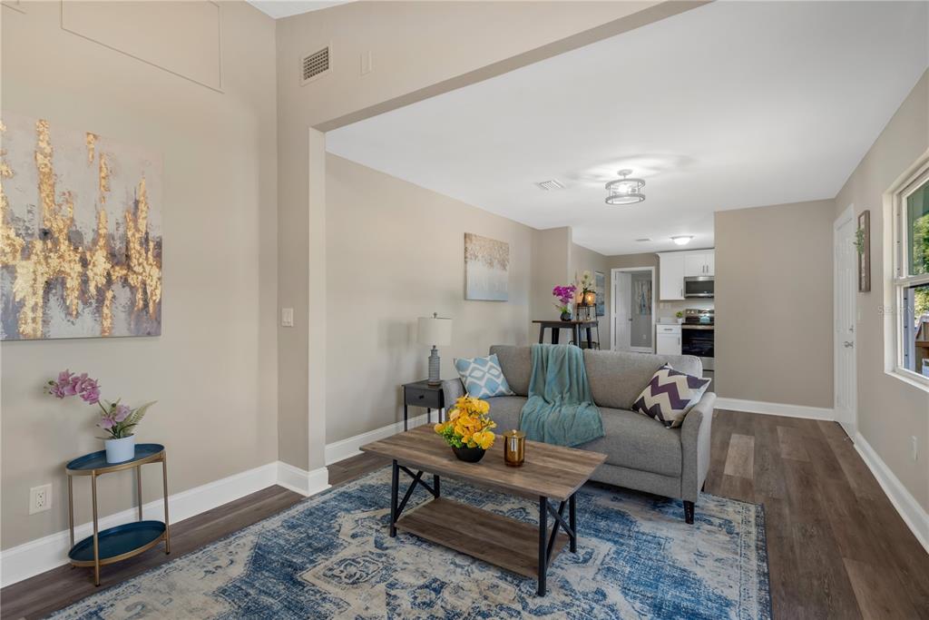 5226 Lime Avenue Seffner, FL 33584 - Photo 5 of 20 a living room with furniture and a dining table with wooden floor