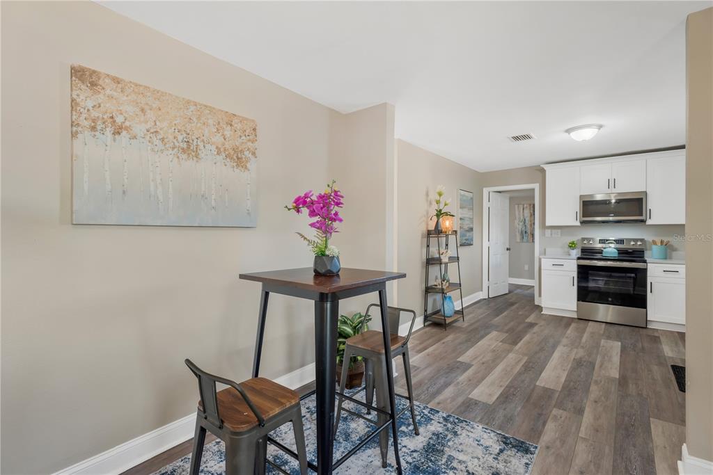 5226 Lime Avenue Seffner, FL 33584 - Photo 8 of 20 a view of a dining room with furniture and wooden floor