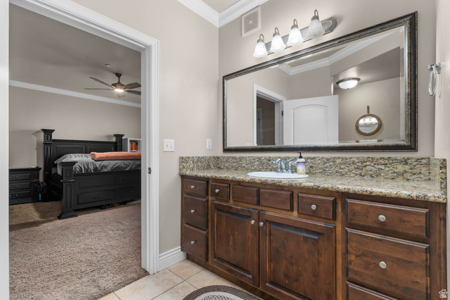 476 West 200 N Street, Unit 206 Springville, UT 84663 - Photo 12 of 24 Bathroom with light colored carpet, crown molding, vanity, light tile patterned flooring, and a ceiling fan