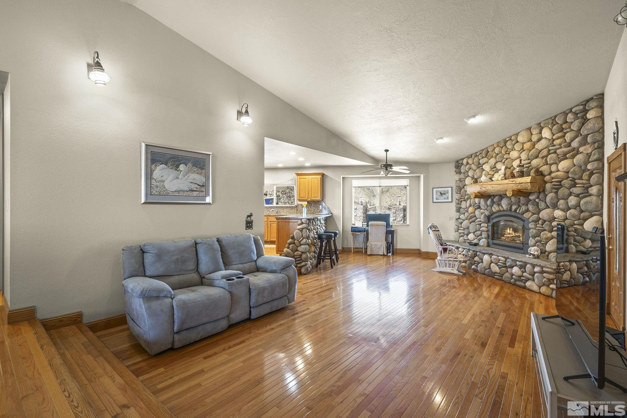 480 Duck Hill Road Washoe Valley, NV 89704 - Photo 14 of 46 a living room with furniture and a wooden floor