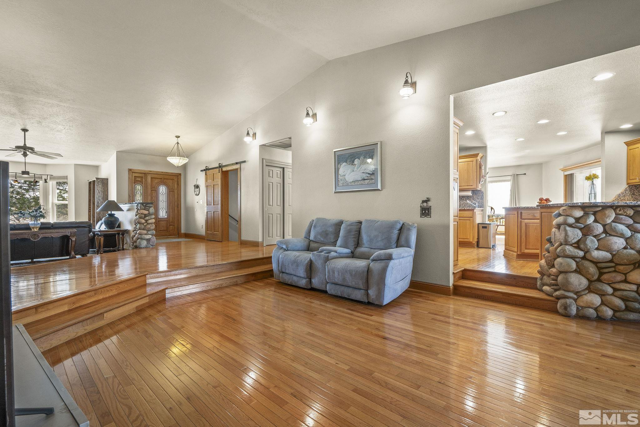 480 Duck Hill Road Washoe Valley, NV 89704 - Photo 15 of 46 a living room with furniture and a dining table with wooden floor