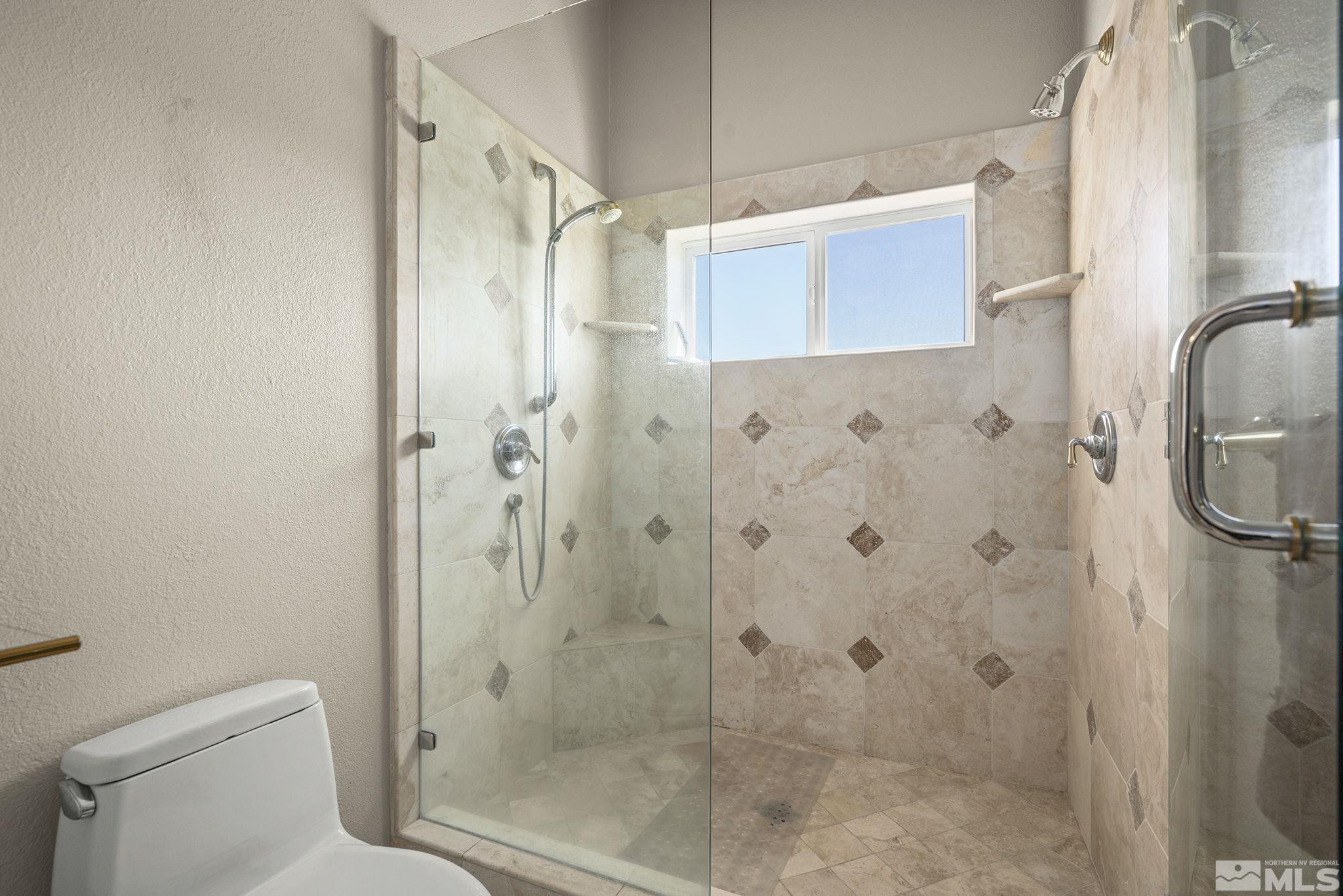 480 Duck Hill Road Washoe Valley, NV 89704 - Photo 22 of 46 a bathroom with a shower and toilet