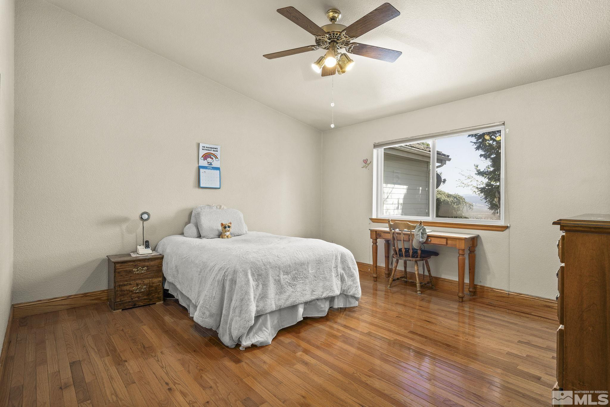 480 Duck Hill Road Washoe Valley, NV 89704 - Photo 23 of 46 a bedroom with a bed and a table