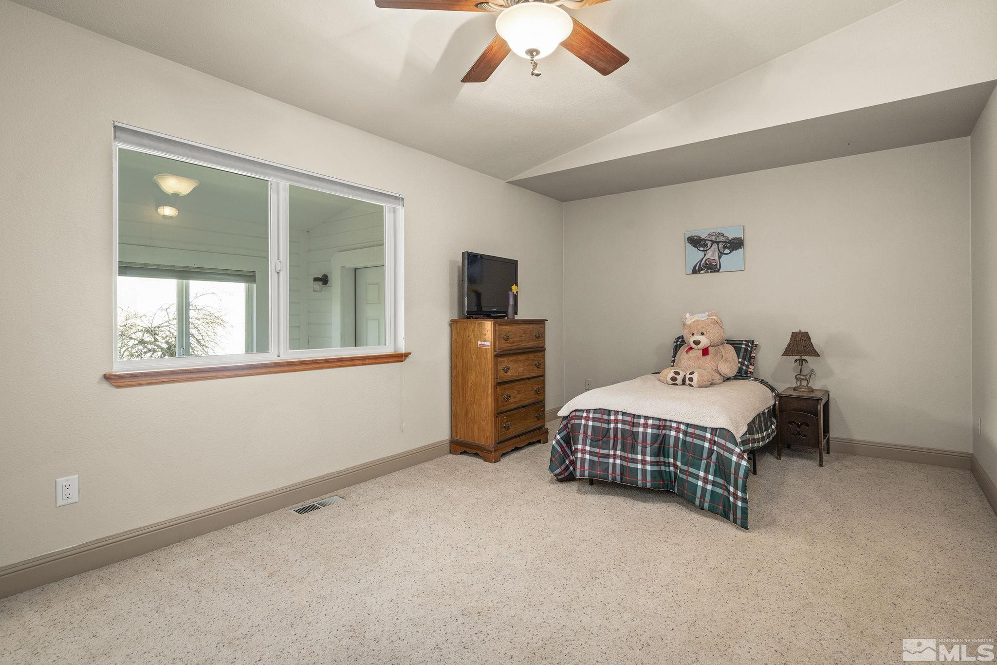 480 Duck Hill Road Washoe Valley, NV 89704 - Photo 25 of 46 a bedroom with a bed and window
