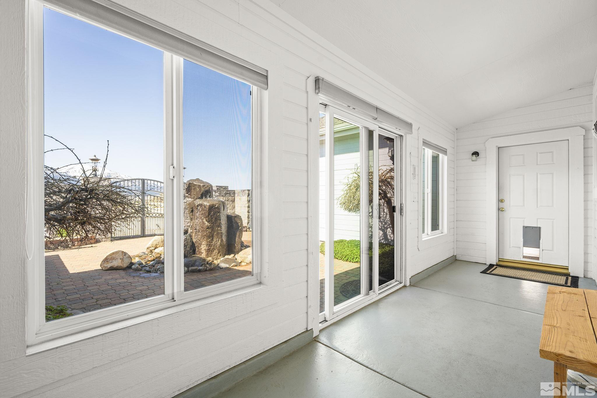 480 Duck Hill Road Washoe Valley, NV 89704 - Photo 28 of 46 a view of a room with a large window and wooden floor
