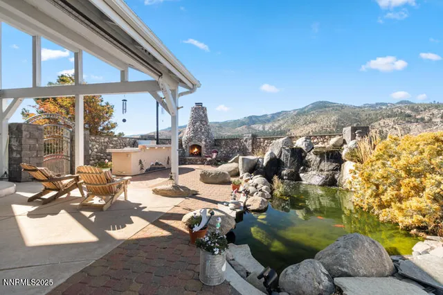 a view of a patio with couches and table and chairs and potted plants