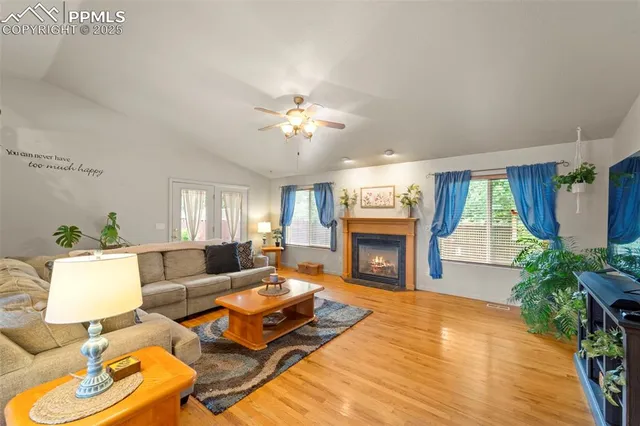 a living room with furniture fireplace and a large window