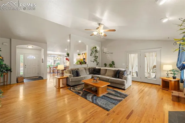 a living room with furniture and wooden floor