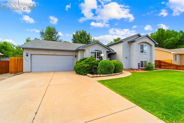 a front view of house with yard and green space