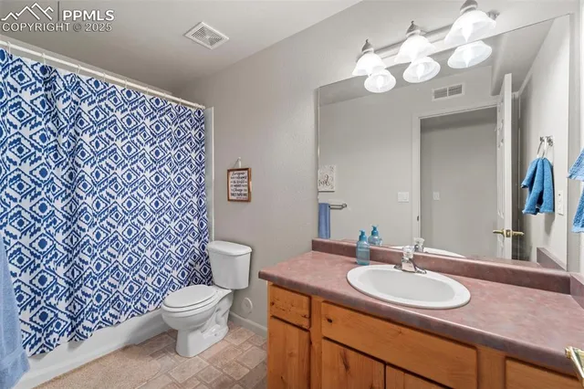 a bathroom with a sink vanity mirror and toilet