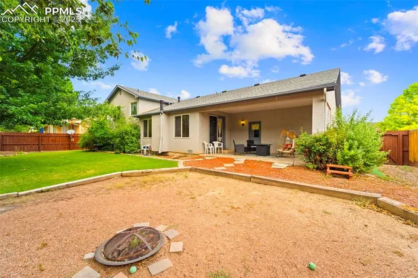 a view of a house with a swimming pool and a yard