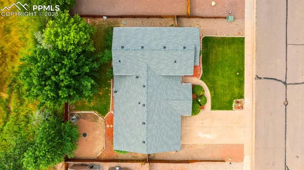 an aerial view of a residential houses with outdoor space