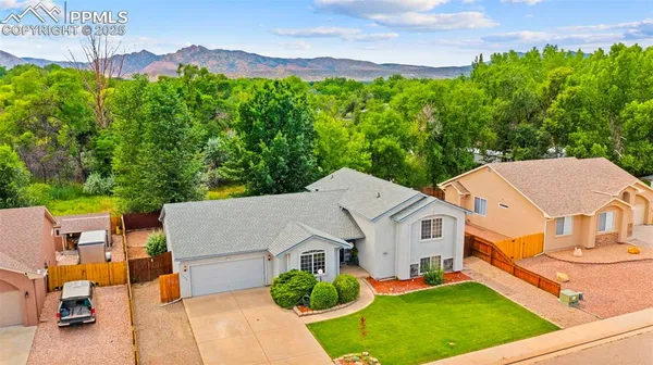 an aerial view of a house with a yard