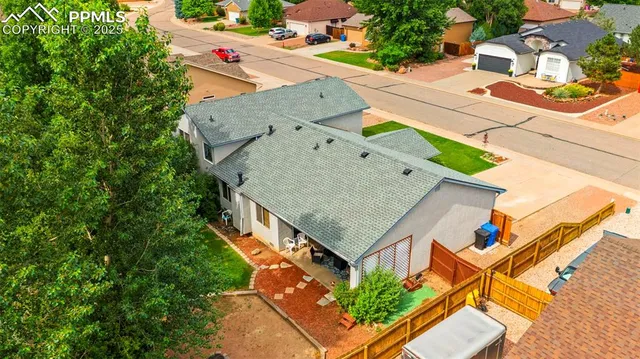 an aerial view of a house with table and chairs