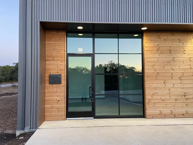 an empty room with windows and ceiling fan