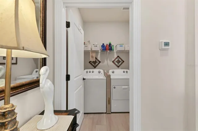 a front view of a house with a yard and potted plants