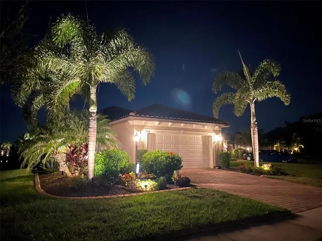 a large kitchen with a large counter top and stainless steel appliances