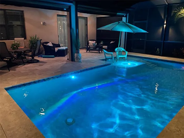 a front view of a house with a garden and lake view