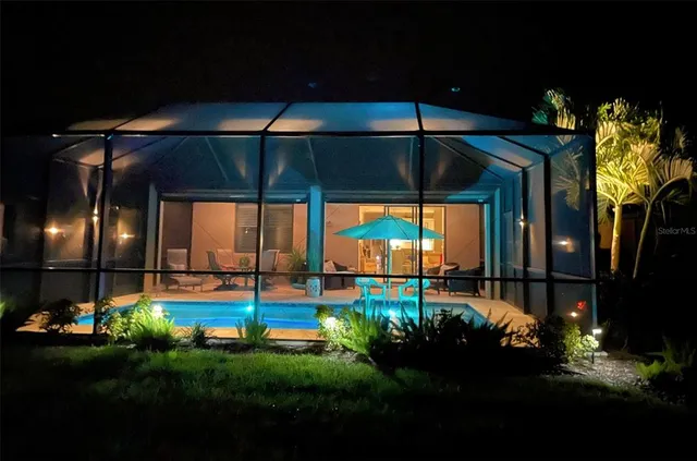 a view of swimming pool with outdoor seating and plants