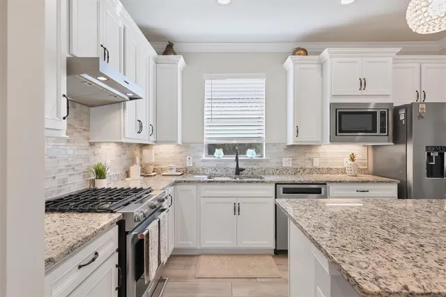 a kitchen with a dining table and chairs