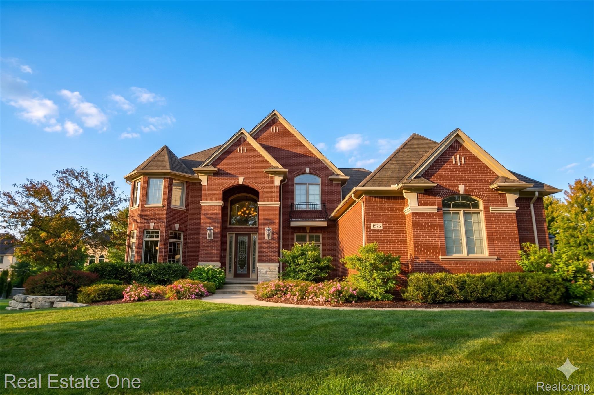 1576 Galena Rochester, MI 48306 - Photo 1 of 2 Grand brick residence featuring a prominent entryway with a transom and sidelights, an arched window above, and a turretted bay window