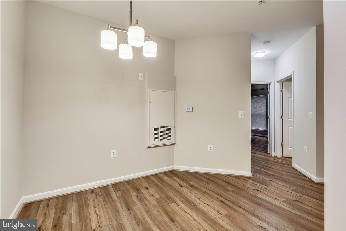 2931 Deer Hollow Way, Unit 102 Fairfax, VA 22031 - Photo 11 of 86 a view of an empty room with wooden floor