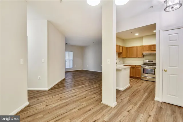 a kitchen with stainless steel appliances granite countertop a sink and a refrigerator