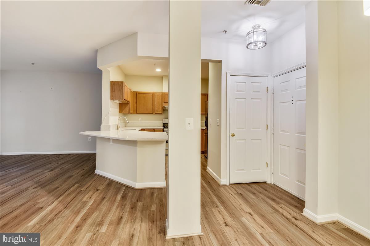 2931 Deer Hollow Way, Unit 102 Fairfax, VA 22031 - Photo 13 of 86 a view of a hallway with wooden floor and a bathroom