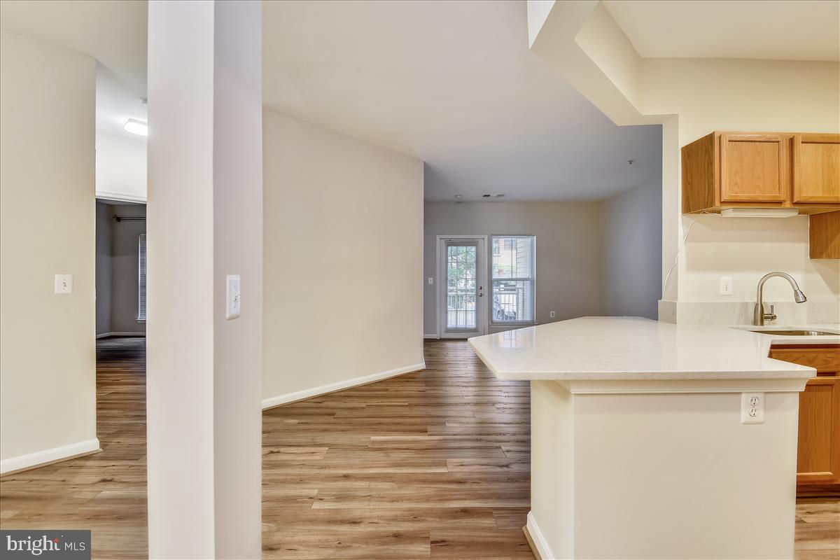 2931 Deer Hollow Way, Unit 102 Fairfax, VA 22031 - Photo 16 of 86 a room with a sink and dishwasher with wooden floor