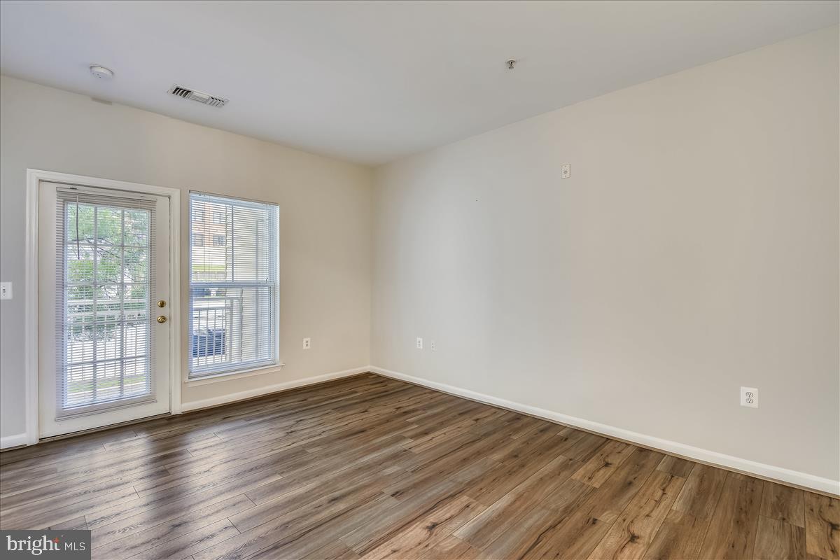 2931 Deer Hollow Way, Unit 102 Fairfax, VA 22031 - Photo 20 of 86 a view of empty room with wooden floor and fan