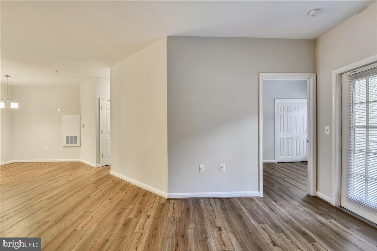 2931 Deer Hollow Way, Unit 102 Fairfax, VA 22031 - Photo 22 of 86 a view of an empty room with wooden floor and a window