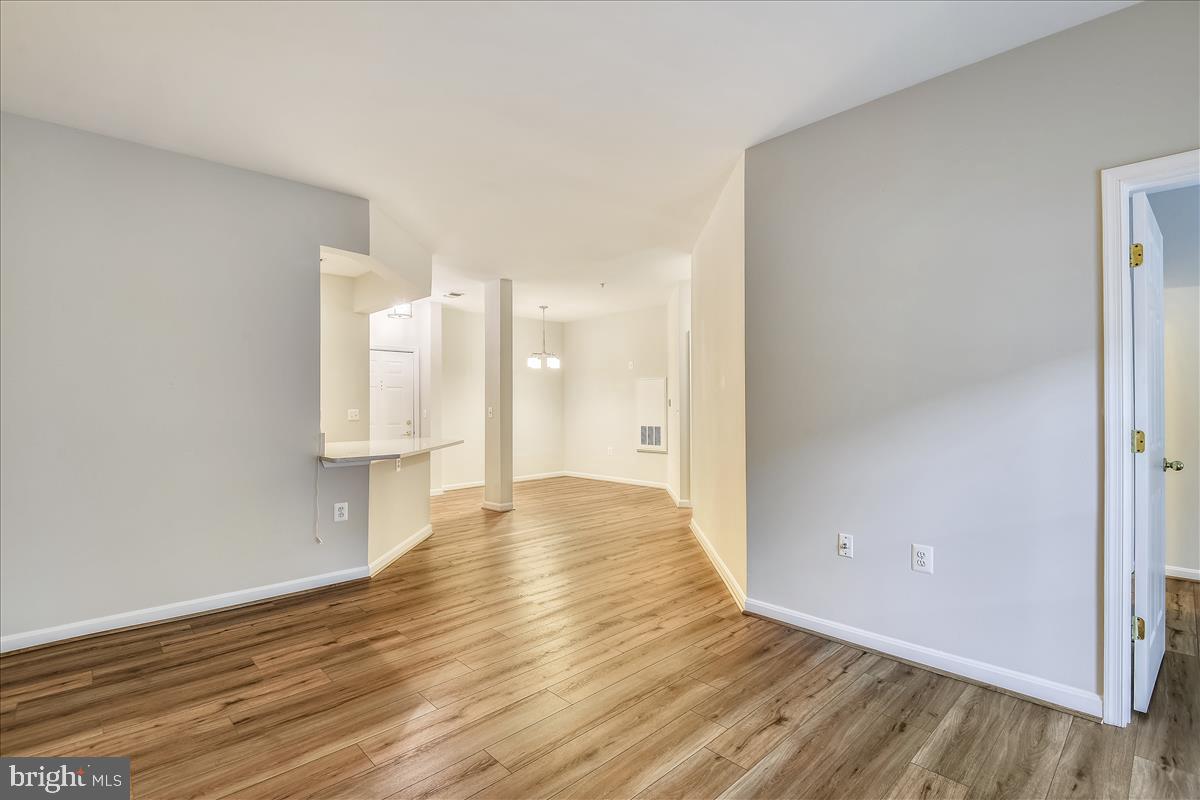 2931 Deer Hollow Way, Unit 102 Fairfax, VA 22031 - Photo 23 of 86 a view of an empty room with wooden floor and a window