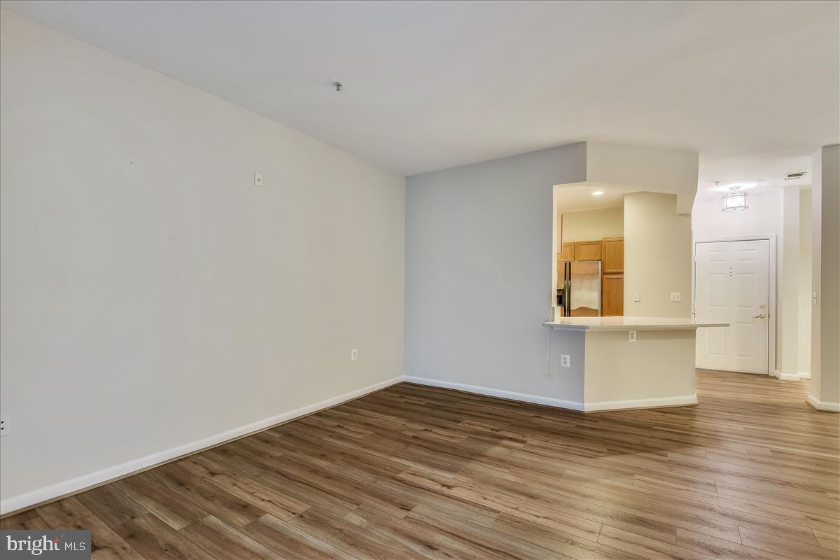 2931 Deer Hollow Way, Unit 102 Fairfax, VA 22031 - Photo 24 of 86 a view of empty room with wooden floor and fan