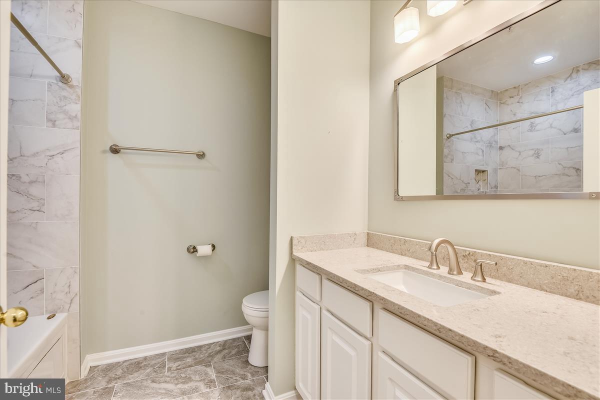 2931 Deer Hollow Way, Unit 102 Fairfax, VA 22031 - Photo 25 of 86 a bathroom with a sink a toilet and shower