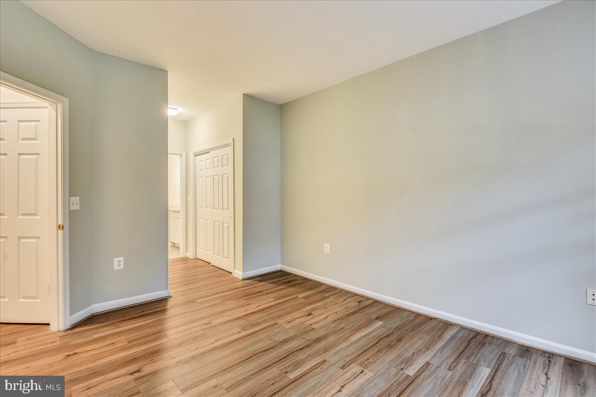 2931 Deer Hollow Way, Unit 102 Fairfax, VA 22031 - Photo 28 of 86 a view of an empty room with wooden floor