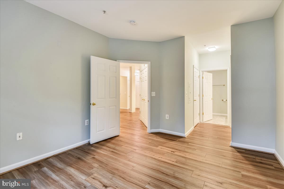2931 Deer Hollow Way, Unit 102 Fairfax, VA 22031 - Photo 29 of 86 a view of an empty room with wooden floor
