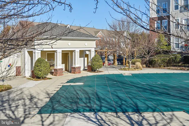 a kitchen with stainless steel appliances kitchen island granite countertop a stove and a white cabinets