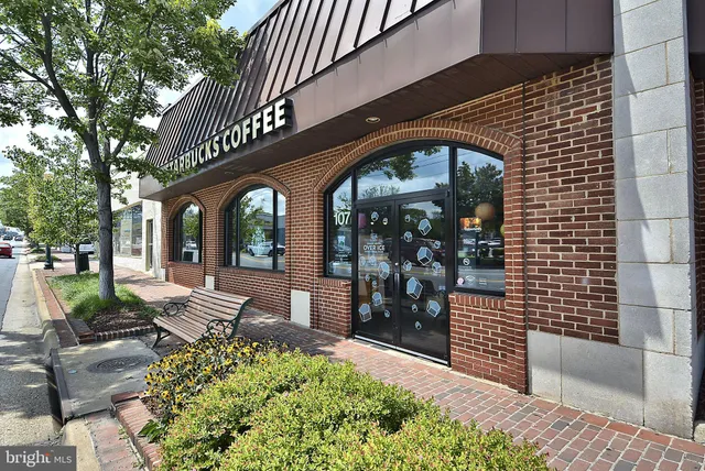 a front view of a house with a fountain