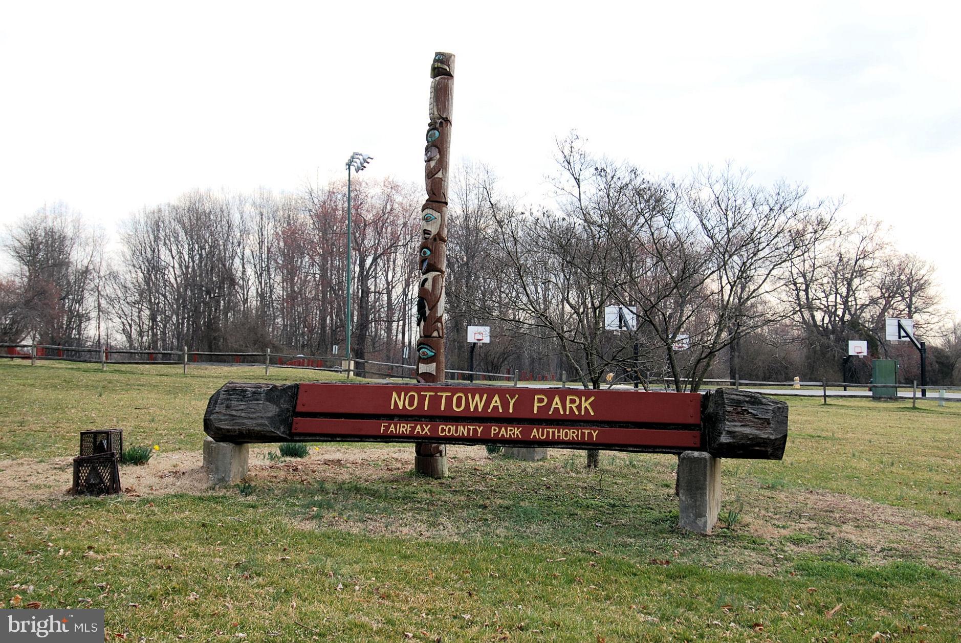 2931 Deer Hollow Way, Unit 102 Fairfax, VA 22031 - Photo 59 of 86 a view of a bench in the river next to a yard