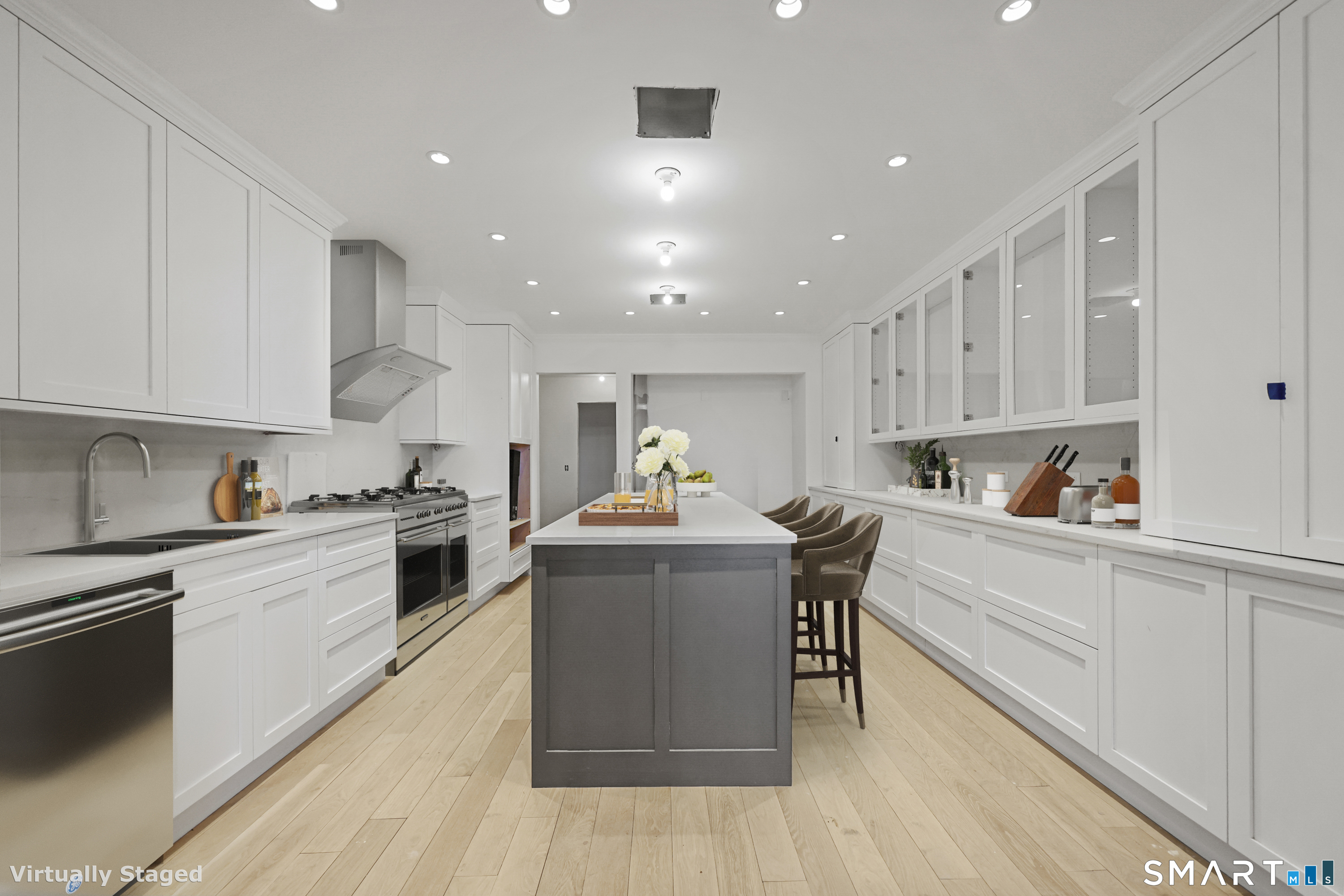 209 Blue Hill Road Great Barrington, MA 01230 - Photo 20 of 37 a kitchen with stainless steel appliances granite countertop a stove top oven a sink dishwasher and white cabinets with wooden floor