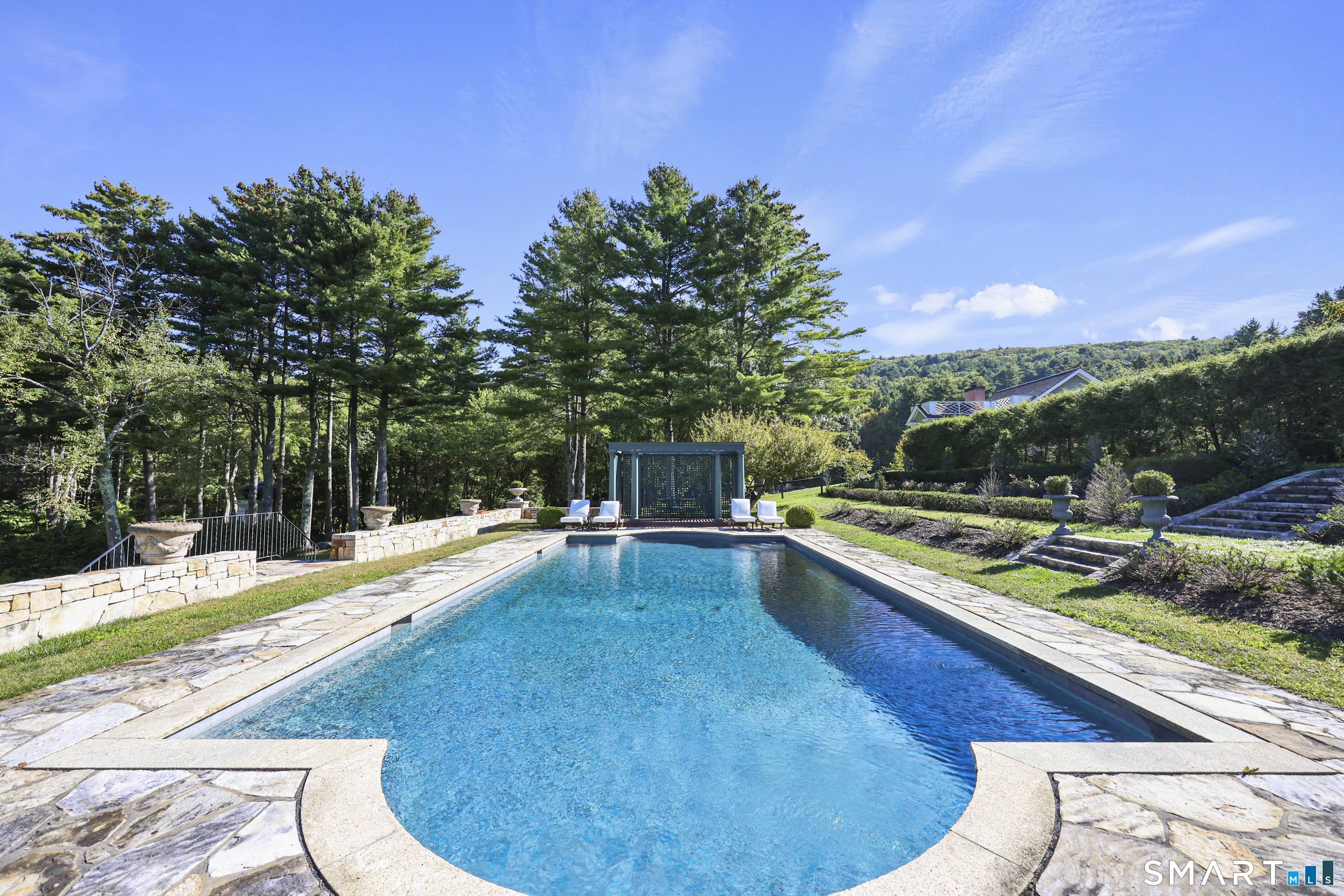 209 Blue Hill Road Great Barrington, MA 01230 - Photo 31 of 37 a view of a swimming pool with a chair and tables