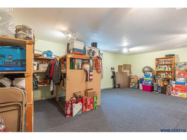 2455 G Street Springfield, OR 97477 - Photo 17 of 32 a storage room with furniture and a flat screen tv