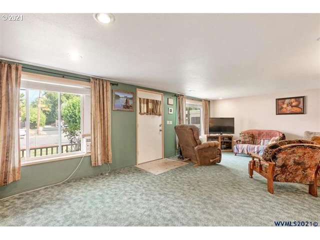 2455 G Street Springfield, OR 97477 - Photo 3 of 32 a living room with furniture and a flat screen tv