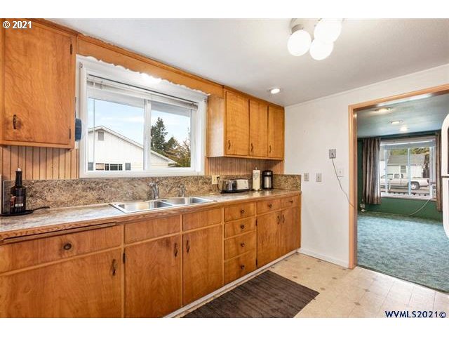 2455 G Street Springfield, OR 97477 - Photo 29 of 32 a kitchen with a sink cabinets and window