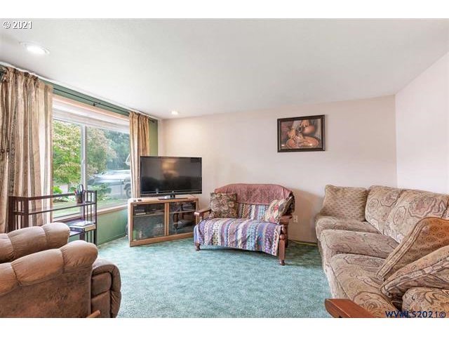 2455 G Street Springfield, OR 97477 - Photo 32 of 32 a living room with furniture and a flat screen tv
