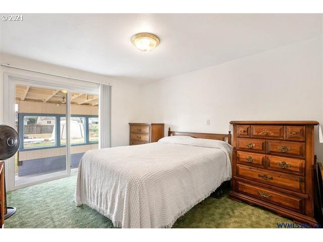 2455 G Street Springfield, OR 97477 - Photo 5 of 32 a bedroom with a bed and a large window
