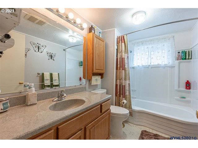 2455 G Street Springfield, OR 97477 - Photo 7 of 32 a bathroom with a sink double vanity granite tub shower and mirror