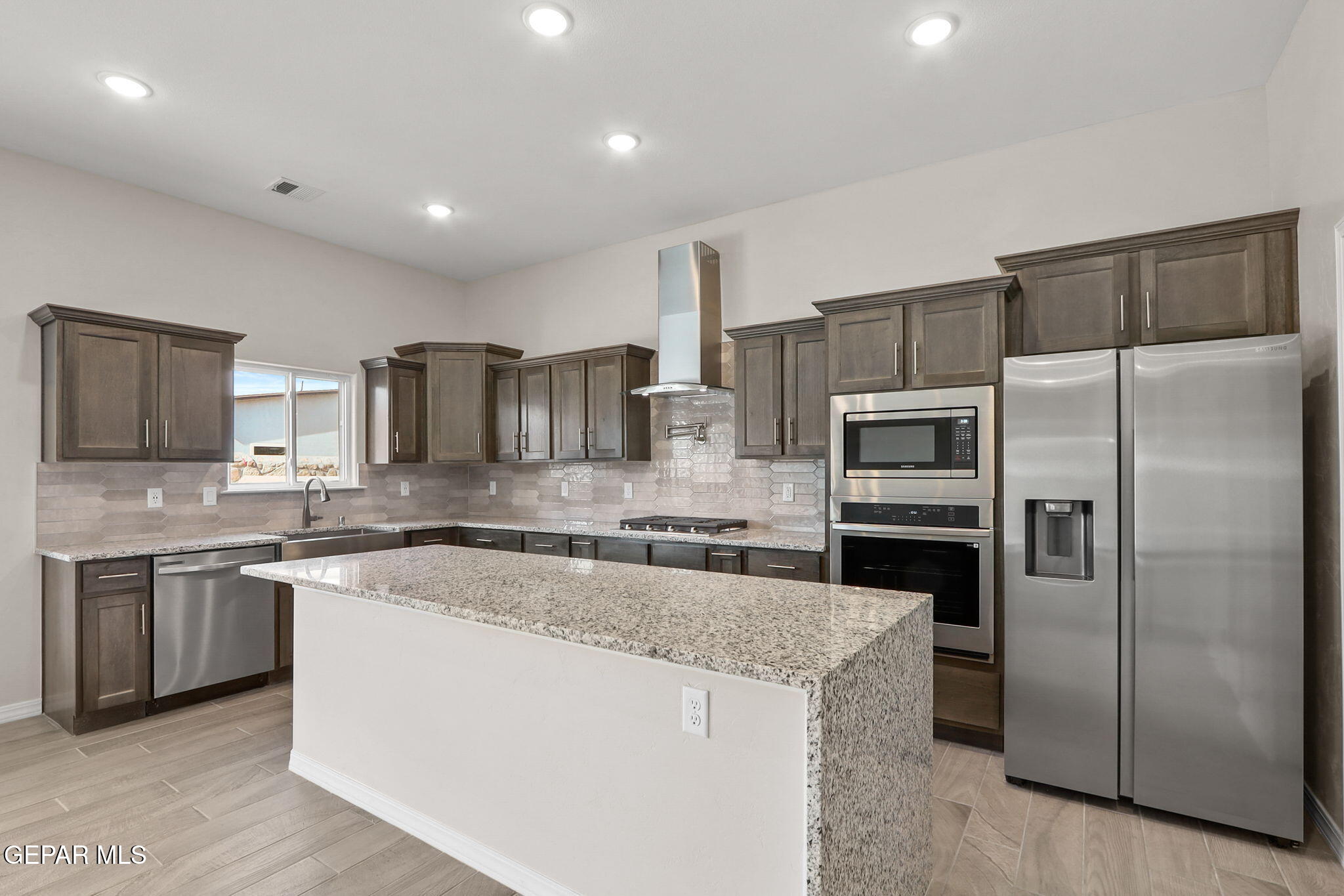 15336 Resolve Street El Paso, TX 79938 - Photo 16 of 32 a kitchen with stainless steel appliances granite countertop a sink stove and refrigerator