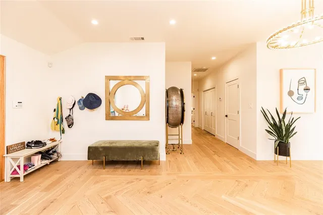 a living room with furniture a large window and kitchen view
