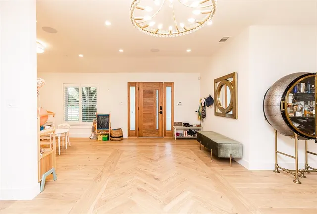 a living room with furniture a flat screen tv and a table